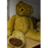 A large musical clockwork Teddy Bear, possibly Merrythought, golden centre seamed body,