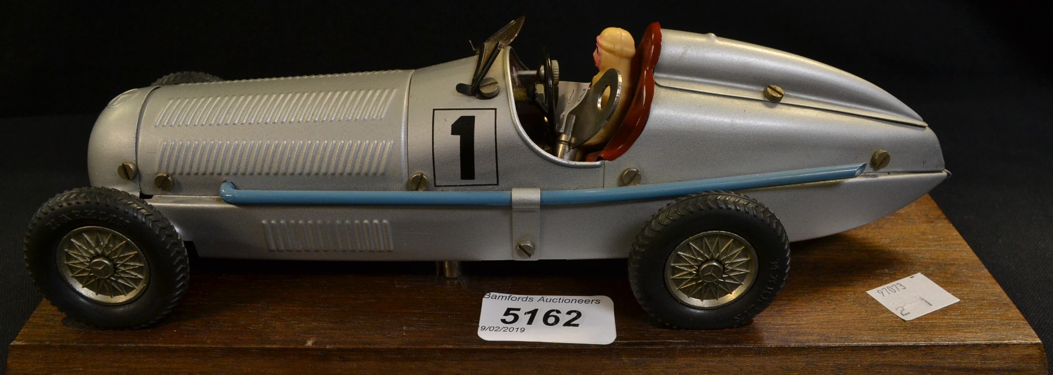 A Marklin Silver Arrow Clockwork Racing Car, silver body, blue exhaust, red interior, cream driver,