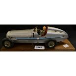 A Marklin Silver Arrow Clockwork Racing Car, silver body, blue exhaust, red interior, cream driver,