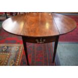 A George III mahogany dropleaf table, single drawer to frieze, tapered square legs,