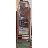 A 20th century mahogany cheval mirror, shaped frame, turned finials, axe handle pivot fittings,