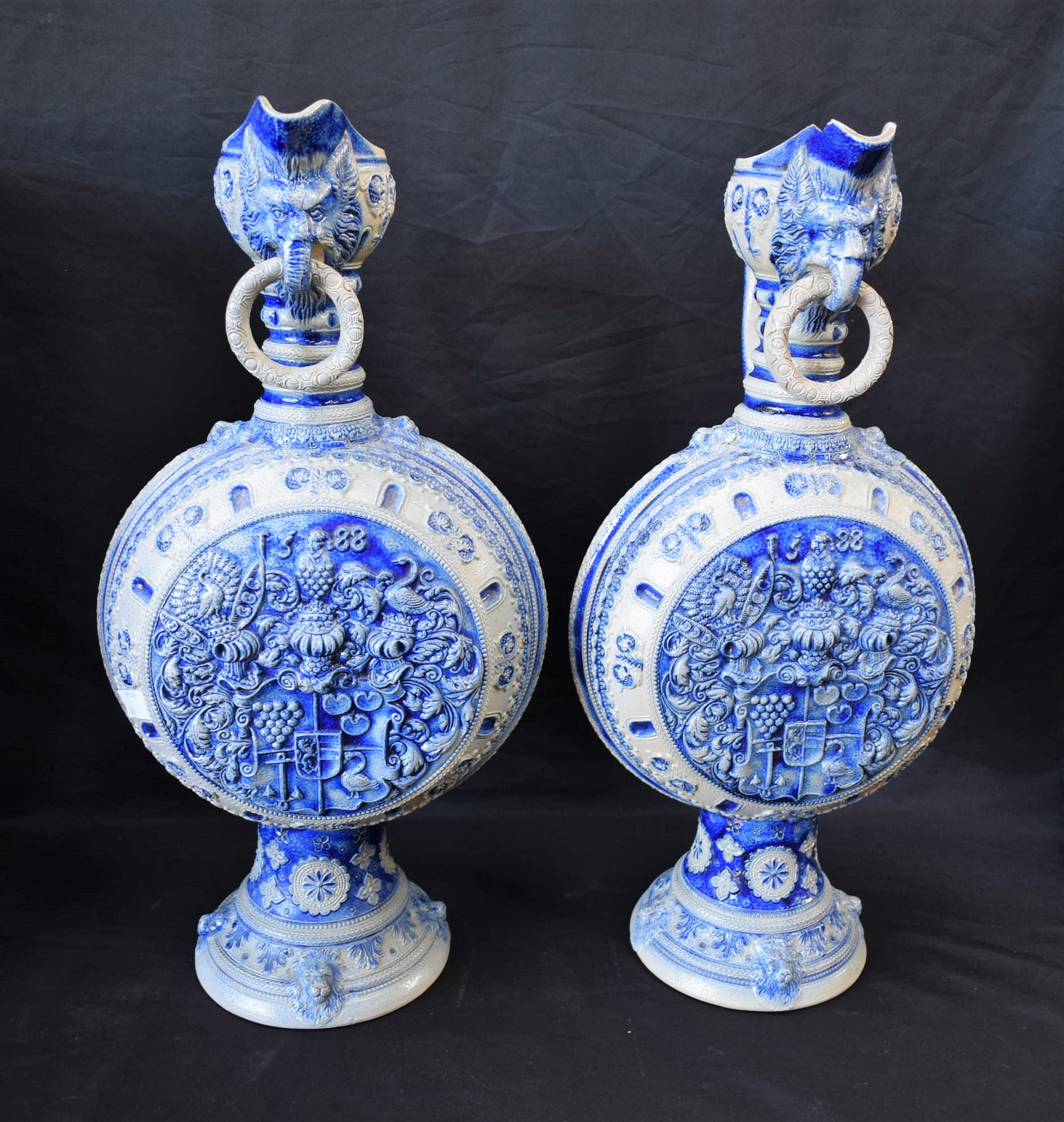 A pair of large 19th century German Westerwald type stoneware armorial jugs,