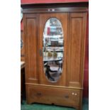 An early 20th century mahogany wardrobe, moulded cornice above a central door,