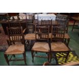 A set of six 20th century oak dining chairs, spindle back, rush seats,