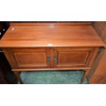 An Edwardian mahogany washstand, half gallery top above a pair of cupboard doors,