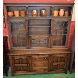 A 20th century oak bookcase, moulded cornice above a pillared niche,