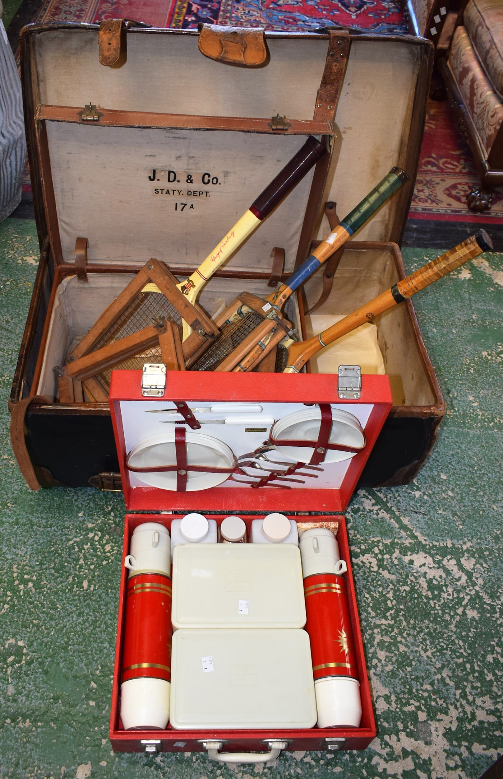 An early 20th century canvas and leather bound trunk; another travel case; a Sirram picnic set;