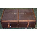 An early 20th century wood bound trunk with leather straps and handles,