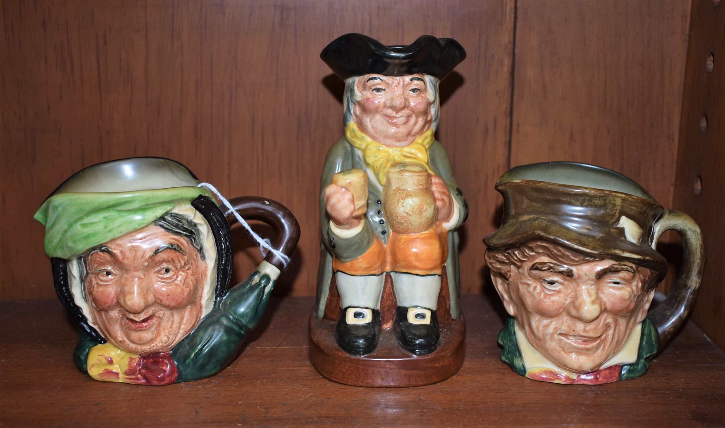 A Royal Doulton Toby jug, Happy John; two Royal Doulton character jugs,