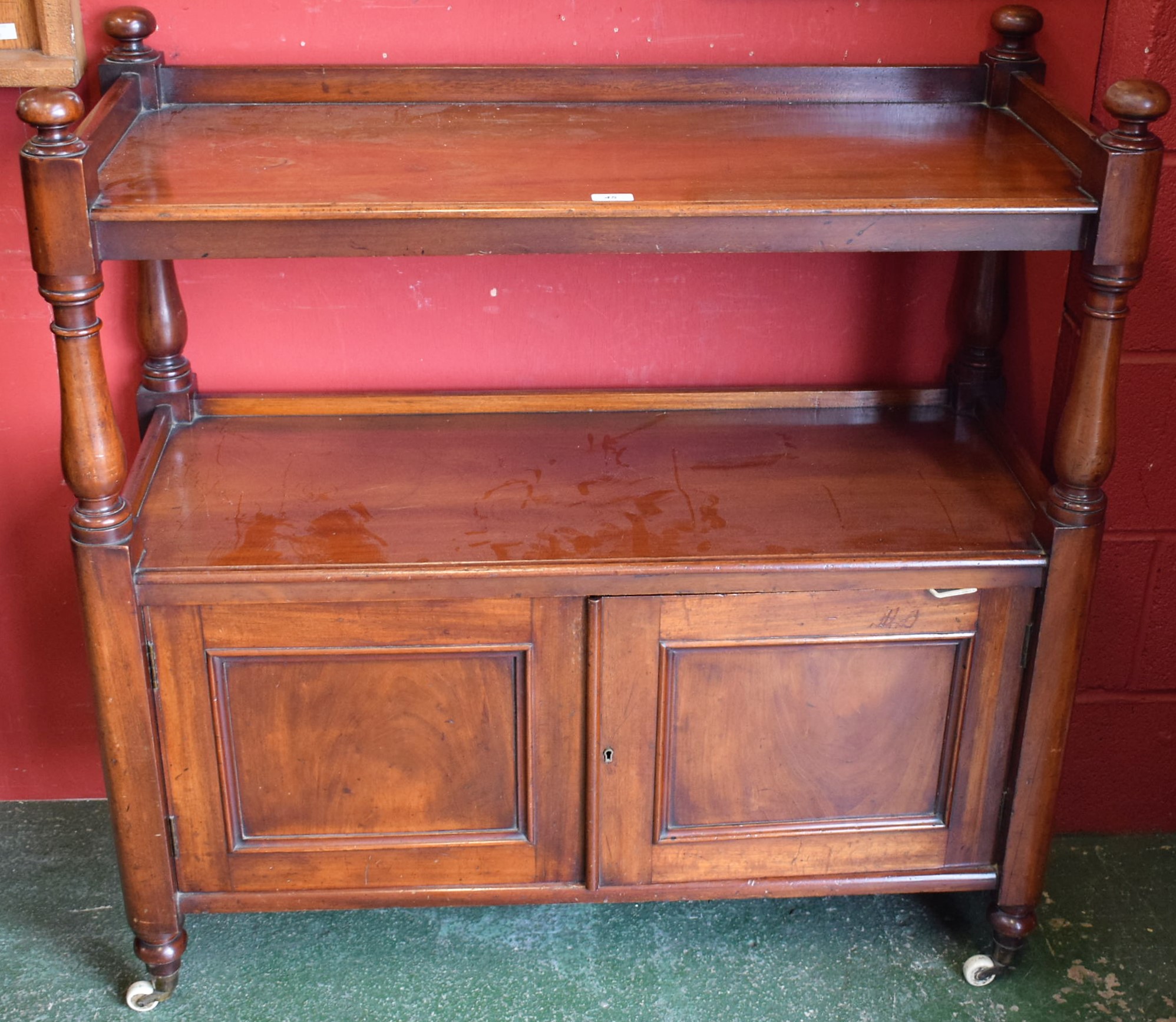 A Victorian mahogany buffet, the two tiers with three quarter galleries, turned pillars and finials,