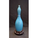 A Japanese Awaji slender double-gourd vase, crackle glazed in merging tones of electric blue,