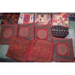 Textiles - a set of four Burgundy and black cushions; others various; a woven woolen rug;