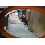 An oval wall mirror, mahogany frame, approx 87.