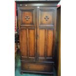 A 20th century oak wardrobe, the pair of moulded doors above a single long drawer, 193.