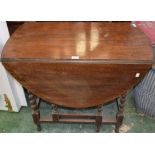 An early 20th century oak gateleg table, spirally turned legs,