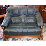 A 20th century oak framed sofa, leather upholstery,