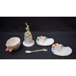 A Franz porcelain teacup, saucer, tea plate and spoon, decorated in relief with flowers,