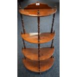 A Victorian rosewood demi-lune four tier whatnot, turned supports, 125cm high, 60cm wide, c.