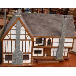 A large scratch built two storey Tudor cottage dolls house,