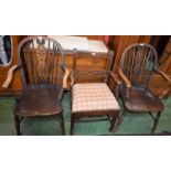 A pair of wheelback armchairs;