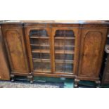A 20th century walnut inverted break-front bookcase,