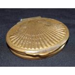 A 19th century oval brass snuff box, the hinged cover decorated with a shell, 7.