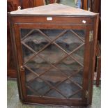 A George III oak wall hanging corner display cabinet,