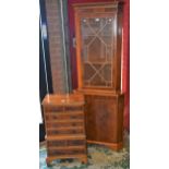 A 20th century yew miniature chest, moulded top above an arrangement of drawers,