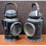 A pair of Great Western Railway hand signal lamps, each with rotating red, amber and green lenses,