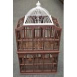 A decorative wooden two tier birdcage