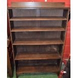 A 20th century oak bookcase, half gallery top above four adjustable shelves,