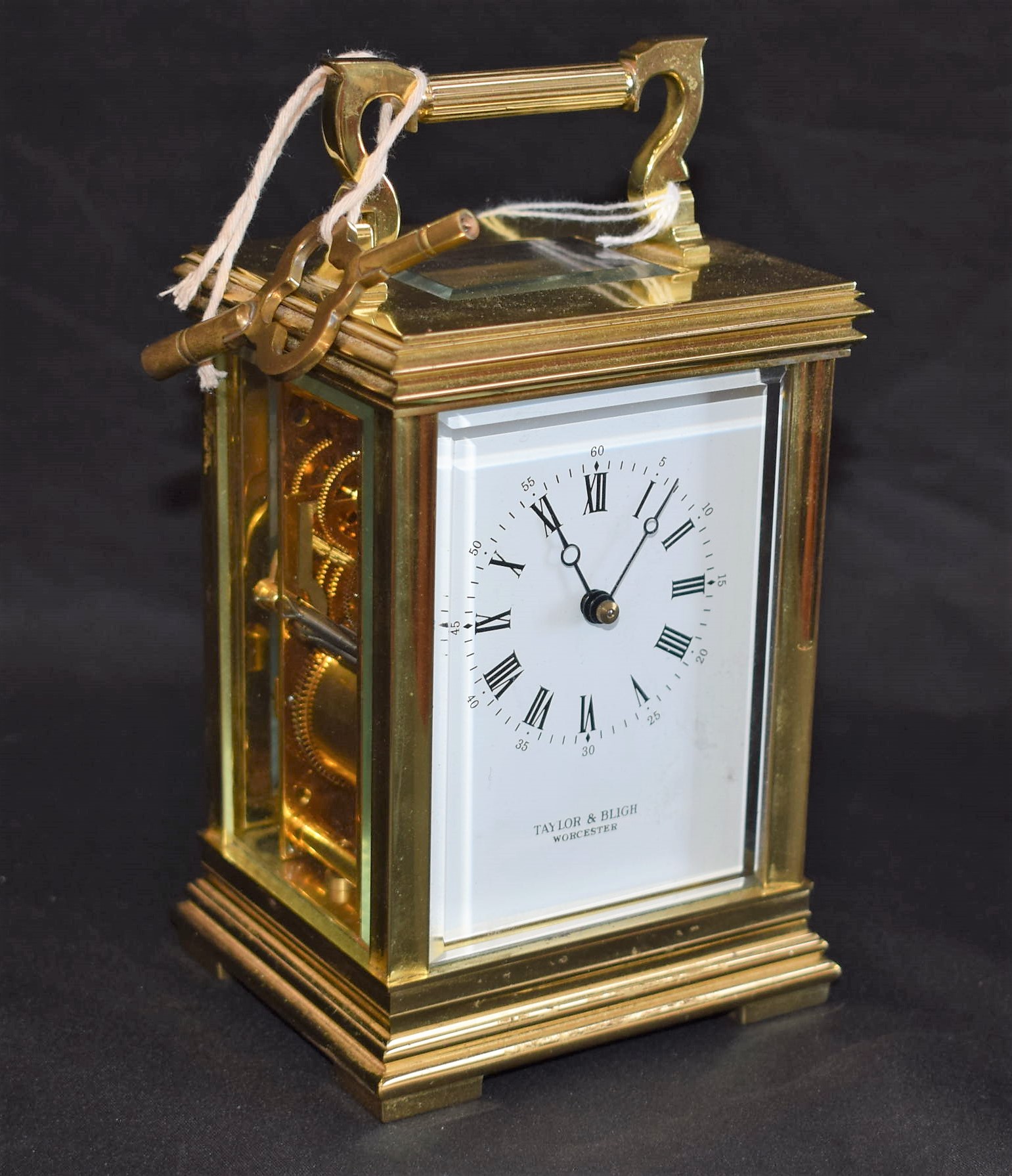 A lacquered brass carriage clock, white rectangular enamel dial, Roman and Arabic numerals,