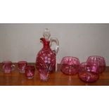 A Victorian ruby glass decanter; four cups,