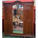 An early 20th century mahogany triple wardrobe,