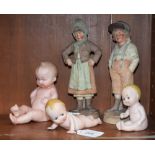 A pair of 19th century German 'biscuit' figures; three babies,