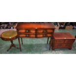 A reproduction mahogany side table, shaped top above four short drawers, tapered square legs,