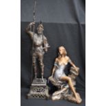 A bronzed metal figure, cast as a Renaissance soldier,
