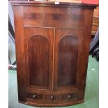 A George IV mahogany bow-fronted wall hanging corner cupboard,