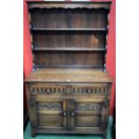 A 20th century oak dresser, moulded cornice above a pair of plate racks,