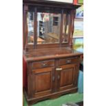 An early 20th century mahogany mirror back sideboard, moulded cornice above a trio of mirrors,