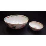 A large Chinese famille verte punch bowl, painted with cockerels, rocks, peonies and other foliage,