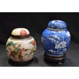 A Chinese blue and white ginger jar on stand, decorated with prunus blossom; another,