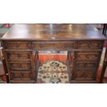 A 20th century oak twin pedestal desk, moulded rectangular top above an arrangement of drawers,