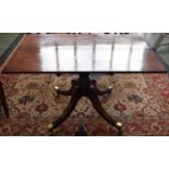 A Regency mahogany dining table, reeded sabre legs, brass casters, 120cm wide, c.