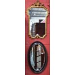 A Regency style shaped rectangular gilt framed wall mirror; another,