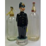 A King George V Ellis soda syphon; another, Schweppes; a novelty decanter,