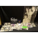 Beatles memorabilia including a set of sixty photocards, lapel badges, silver beatles charm,