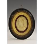 A 19th century oval cameo plaque, in relief with a Bacchic maiden, bust length in profile,