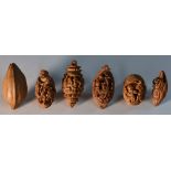 A Chinese coquilla nut carving, as an official seated in a rickshaw, 3cm long,