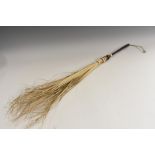 A Colonial fly whisk, turned hardwood haft, 69cm long overall,